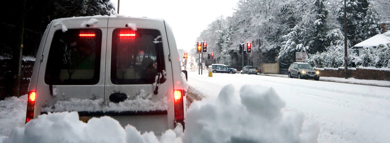 Snowy street from inside car